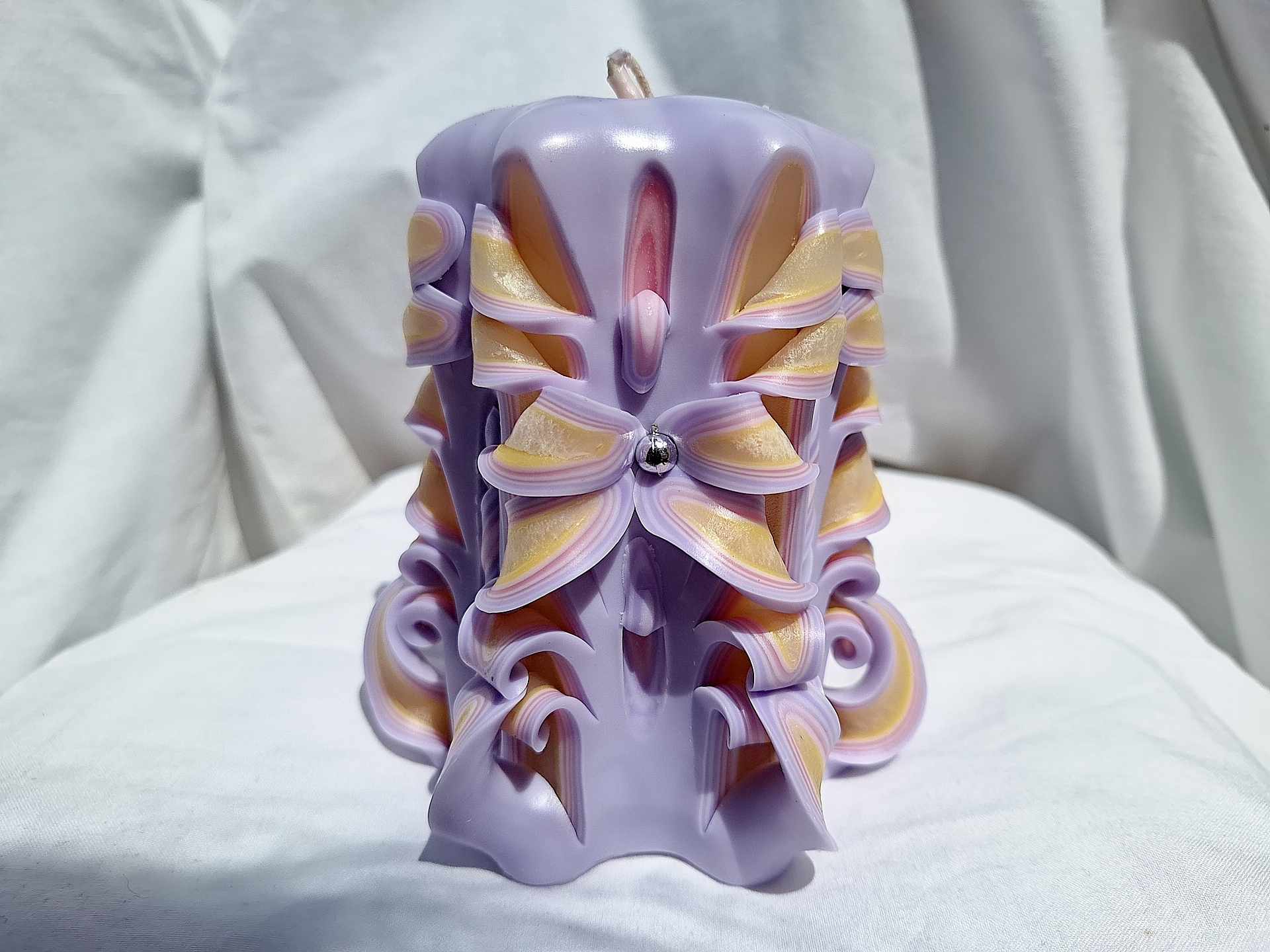 Handmade floral candle in purple with intricate design