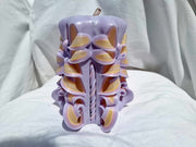 Handmade floral candle in purple with intricate design