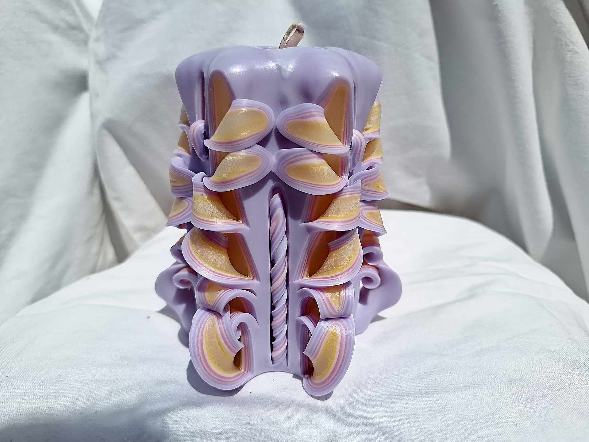 Handmade floral candle in purple with intricate design