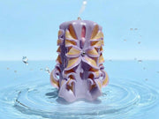 Handmade floral candle in purple with intricate design
