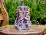 Handmade floral candle in purple with intricate design
