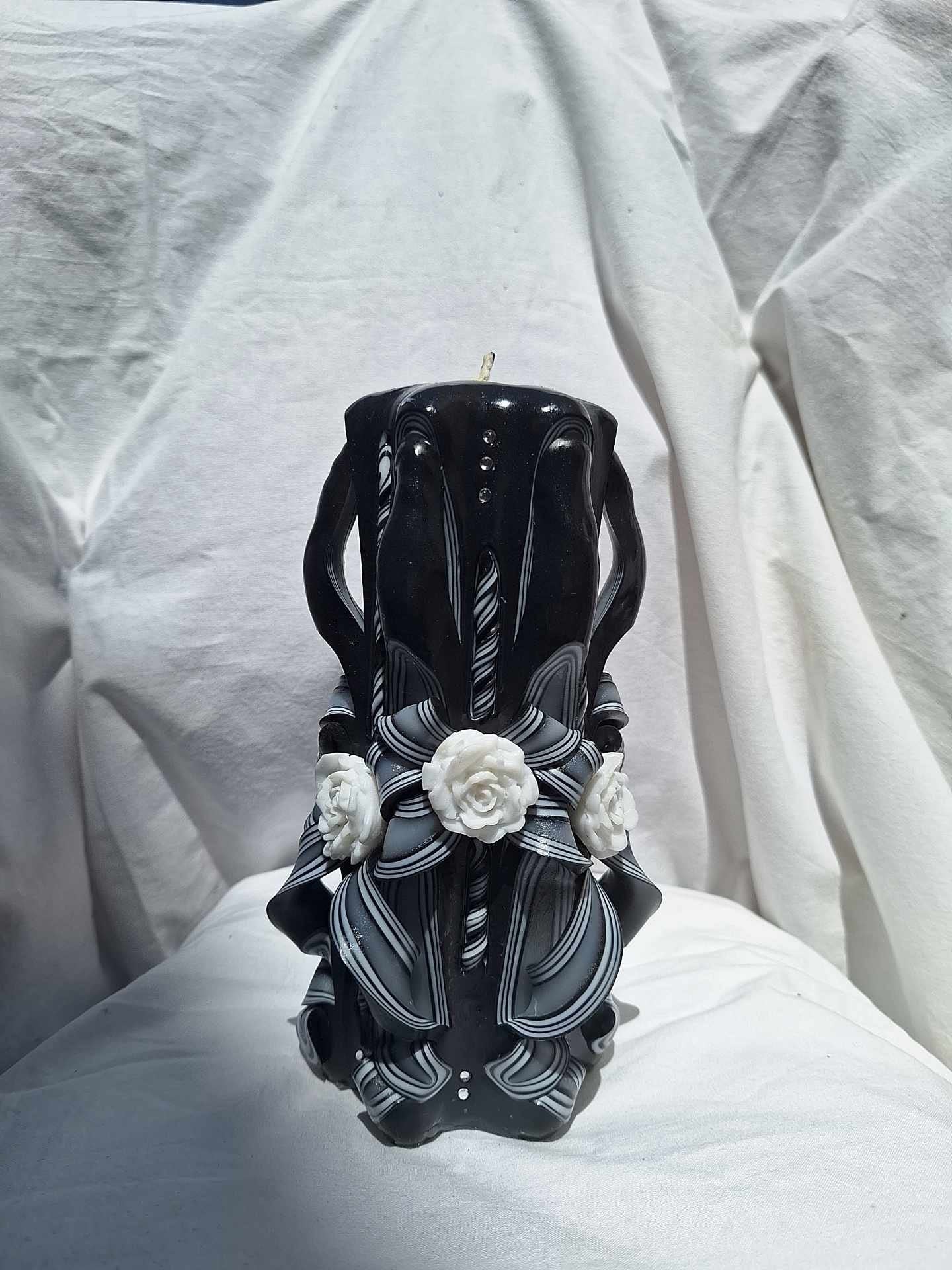 Black and white carved rose candle floral design