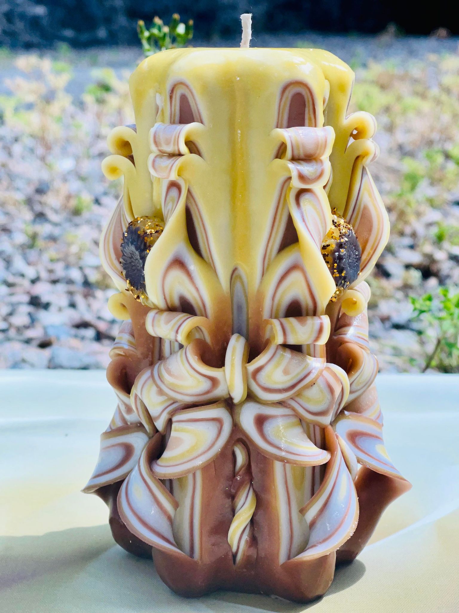 Handmade sunflower candle with floral design