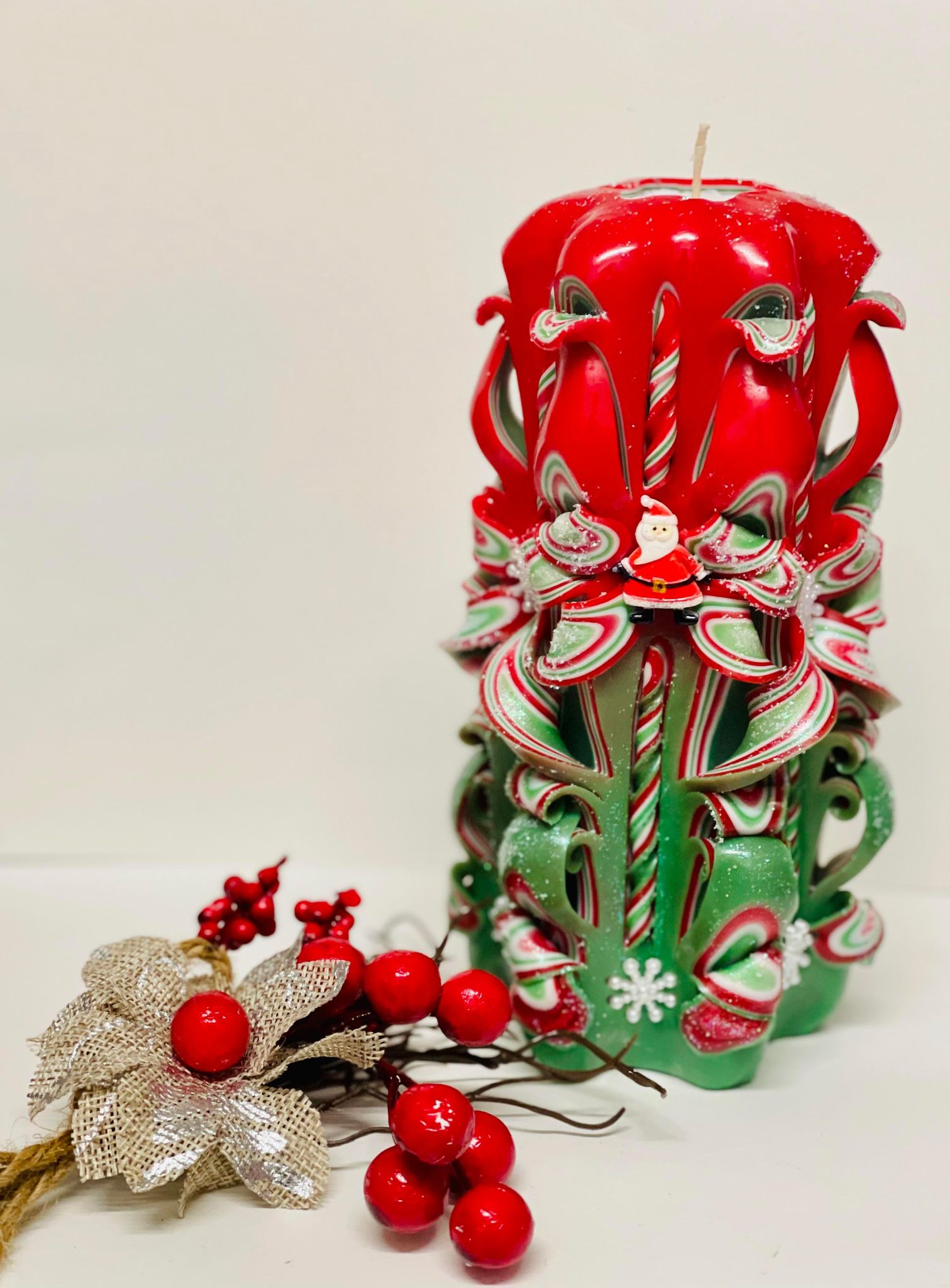 Red and green carved Christmas candle centerpiece