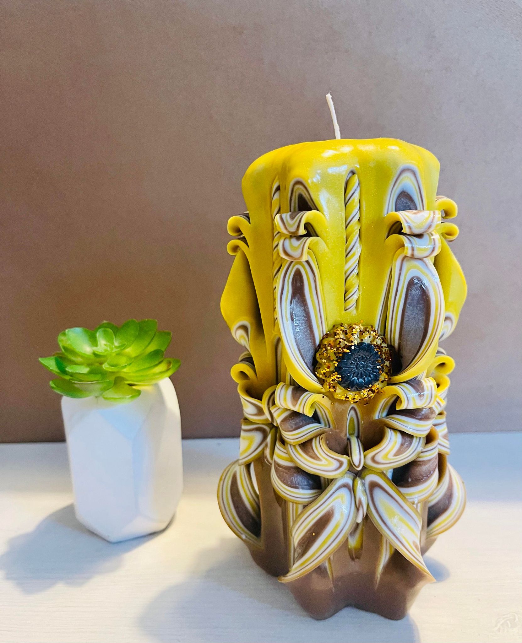 Handmade sunflower candle with floral design