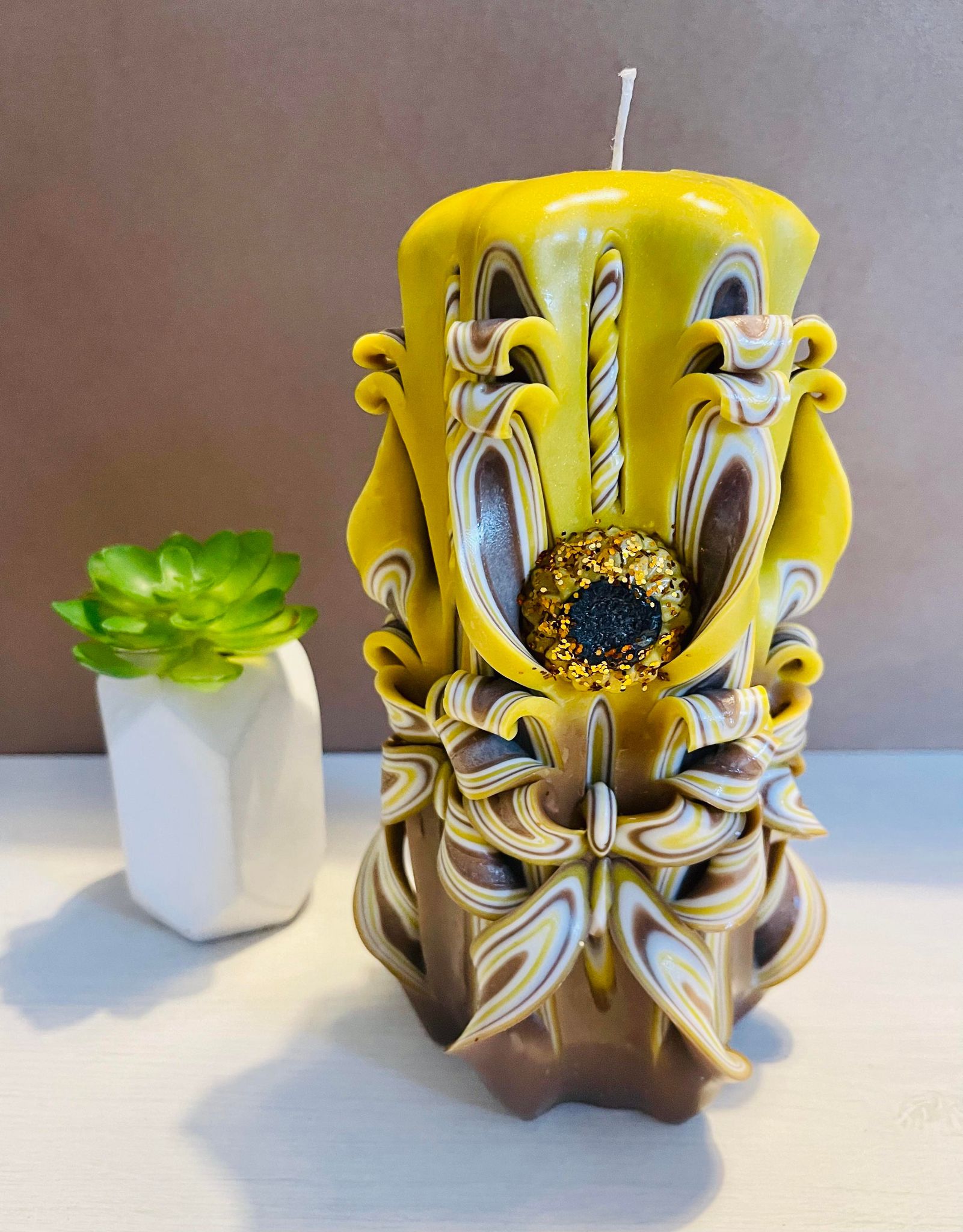 Handmade sunflower candle with floral design